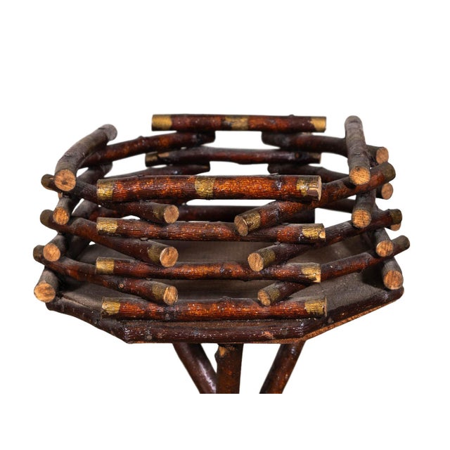 Rustic Adirondack style side table or plant stand. Twig tripod base and basket style top. Natural finish with hand painted...