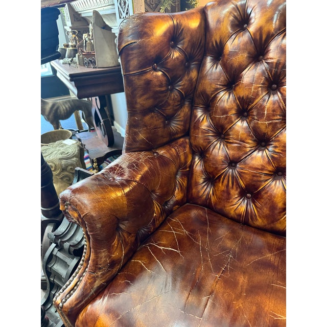 Very handsome vintage tufted leather wingback chair in the Chesterfield style. It is the perfect classic cognac brown...