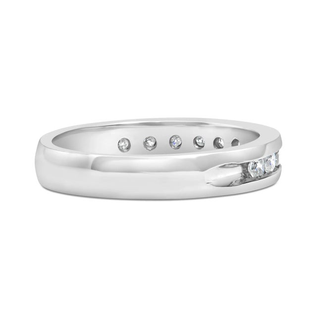 Elegant and timeless, this diamond wedding band features 1/2 carat total weight of diamonds with eleven individual stones....