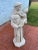 Lovely cement sculpture of St. Anthony draped in a monk's robe and holding a baby in his arms.