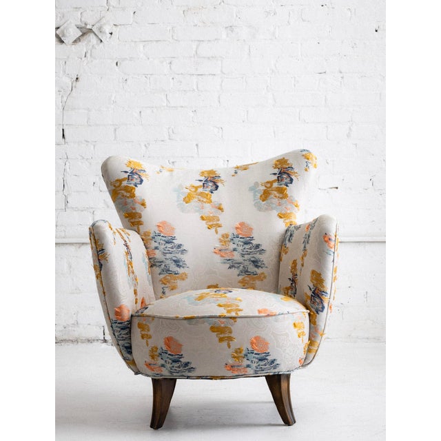A petite mid century armchair newly upholstered in fabric from Dedar Milano. “Say Goodbye Flora” is a Lampas jacquard made...