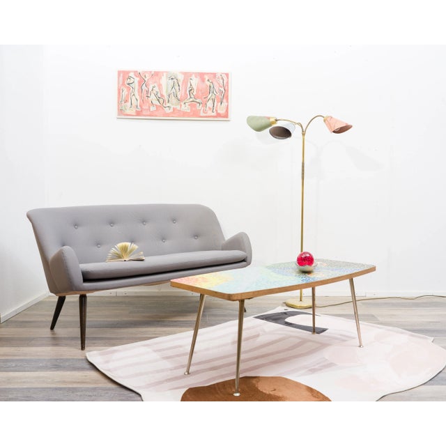 Rare, high-quality mosaic coffee table from the 1950s. A colorful abstract motif is placed on a chipboard and encircled by...