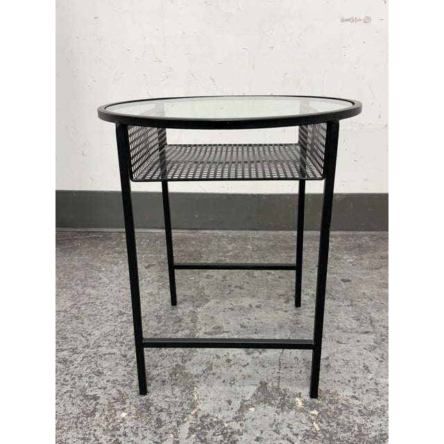 Design Plus Gallery presents a Round Side Table. It features a sturdy metal frame, with a clear glass top and a perforated...