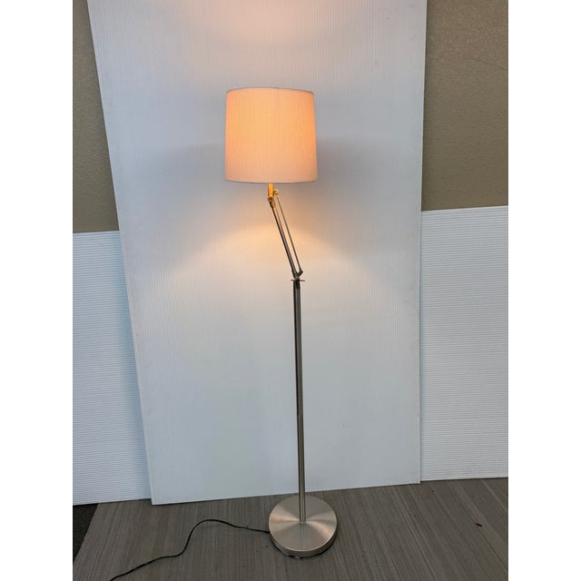 Design Plus Gallery presents a Cantilevered Floor Lamp with Contemporary Style. The base has a nickel finish with a swing...