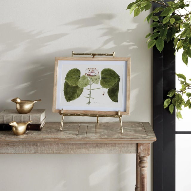 Made to hold platters, cookbooks or a small piece of art, this easel is strong and sturdy. The gold bamboo-like details...