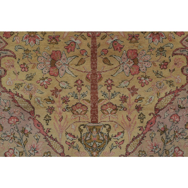 Hand-knotted in silk, circa 1920-1929, this rare 4x6 antique Persian Qum rug highlights a breathtaking tree of life and...