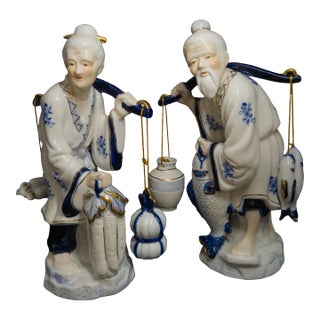 Vintage Indonesian Porcelain Figurine Pair – Elderly Man & Woman With Fish, Buckets & Gold Accents For Sale