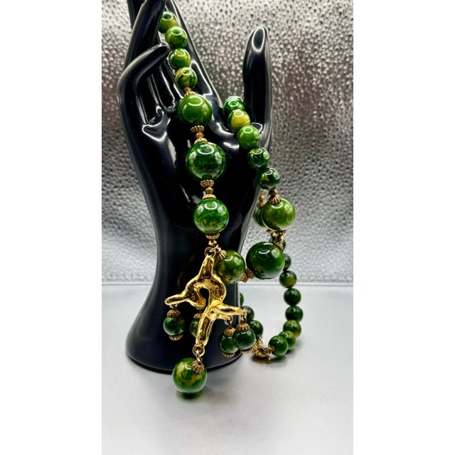 This stunning necklace features rich green spinach color beads complemented by playful gold pendent with a monkey holding...