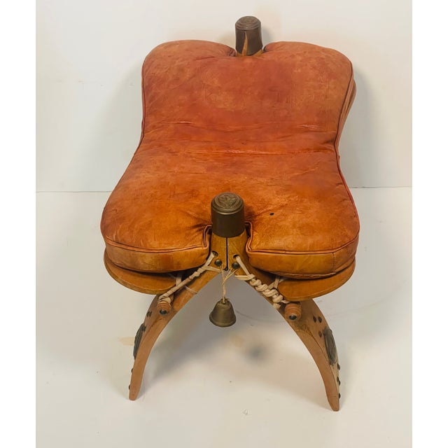 Shabby Chic Antique Moroccan Camel Saddle Leather Footstool With Bronze Bell For Sale - Image 3 of 5