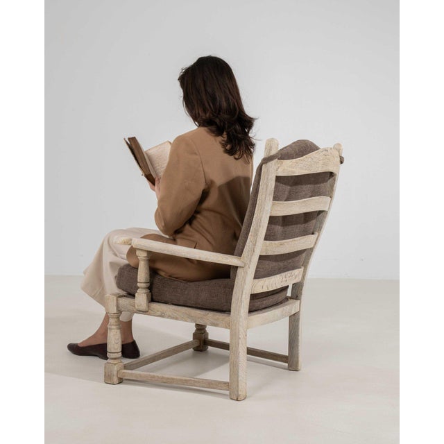 This piece makes its impression through natural bleached oak, taupe cushion. It was made in France during 1970s, a lineage...