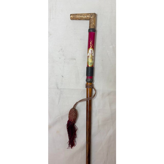 This antique 19th century Victorian hand chased yellow gold filled, wood, and porcelain cane is a unique and elegant...