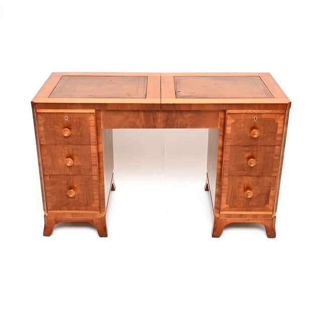 A superb Art Deco figured walnut leather top desk / dressing table , made in England and dating from the 1930’s. This is...
