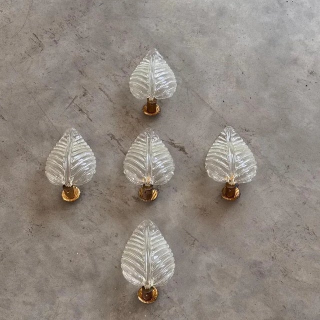 Refined wall sconces produced by Barovier & Toso in the 1940s. Each piece features a gently curved, ribbed leaf in pressed...