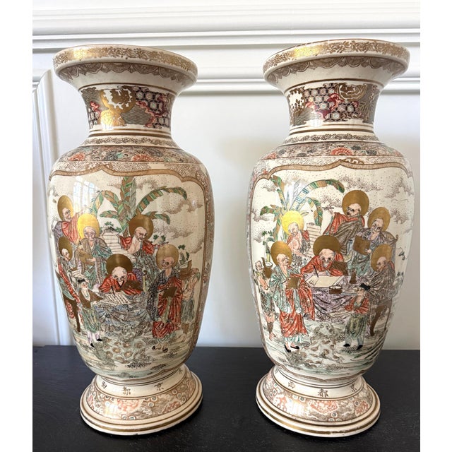 A pair of spectacularly decorated Japanese ceramic vases from late Meiji period circa 1900s by Kozan, a maker in Kyoto...