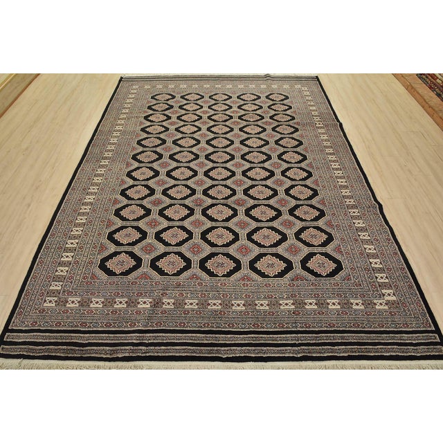 A tribal Bokhara Jaldar rug hand-knotted with fine wool on a cotton foundation. This rug features rows of repeating...
