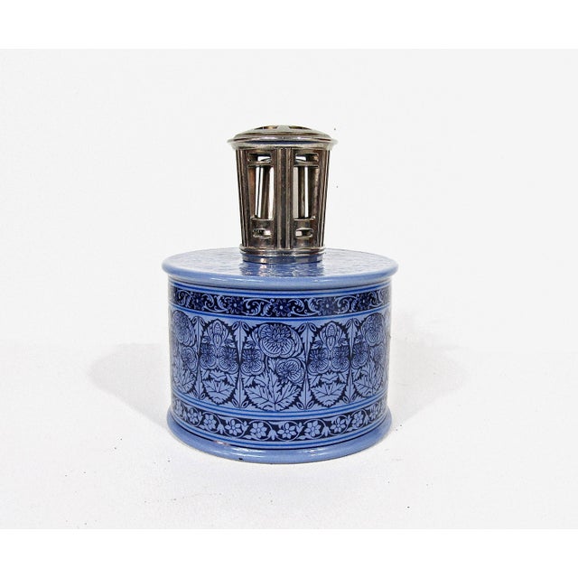 A sculptural little French fragrance lamp—Revol porcelain, periwinkle glaze, and a crisp floral frieze. Stamped “REVOL...