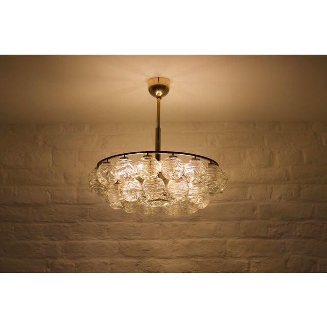 Chandelier or ceiling light called “snowballs” with a circular structure in solid brass, equipped with 27 blown crystal...