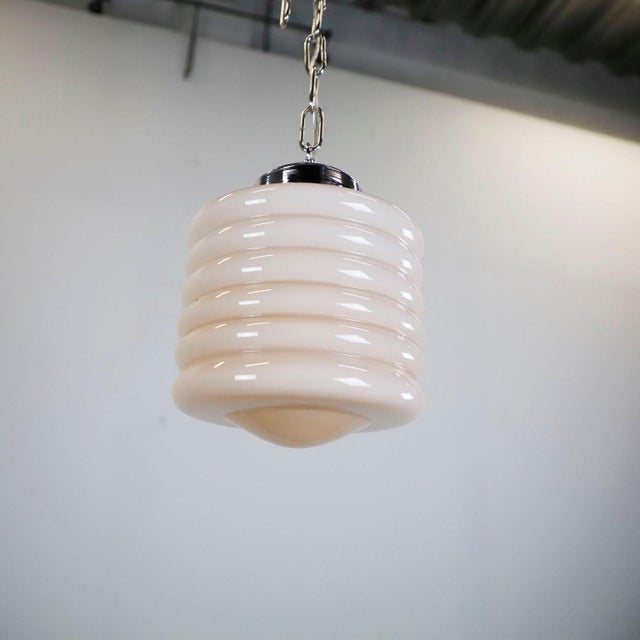 Circa 1950. We offer this Art Deco Pink Glass Pendant Light. The entire electrical system is new and works perfectly.