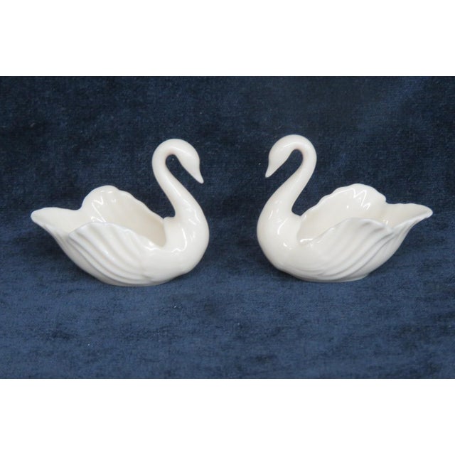 This lovely Pair of Swan Figurines is made of porcelain. Both of these darling miniatures are marked on the bottom as...