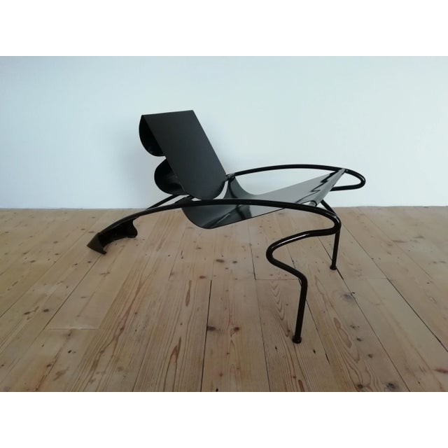 This Memphis design is from the 80s. The whole chair is made of solid steel and is quite heavy. It's most likely that the...