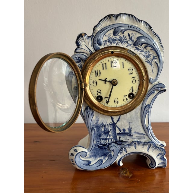 Late 1800s Delft mantle clock, made in the French Rococo style. Porcelain frame likely made in France while the clock...
