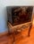 A vintage Asian Chinoiserie file cabinet with a stand, featuring Chinese-inspired motifs and craftsmanship. Black lacquer...