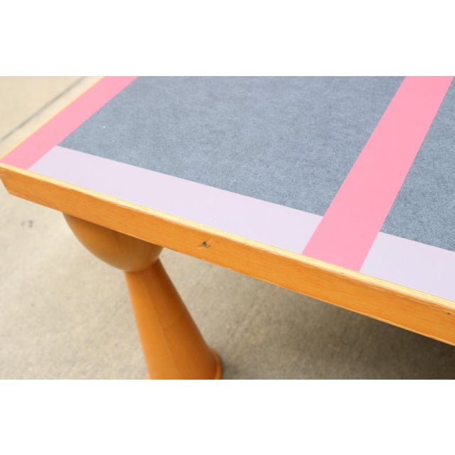 A cocktail table designed by Ettore Sottsass for Zanotta. Multi-colored laminated inset design on the top. Condition is...