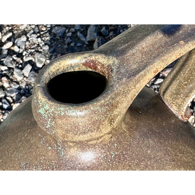 Large, handcrafted floor vase with a handle, a product of German studio ceramics from the 1980s. The glaze features a...