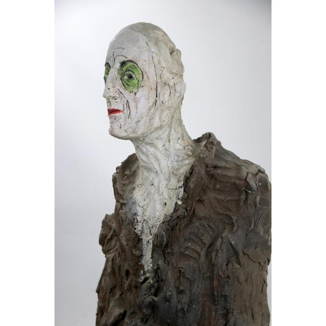 Figurative ceramic bust sculpture with textured coat and expressive glaze, created in high-temperature reduction firing...