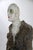 Figurative ceramic bust sculpture with textured coat and expressive glaze, created in high-temperature reduction firing...