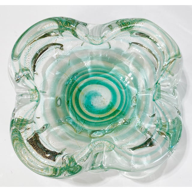 Beautiful vintage Murano style blown glass bowl featuring emerald green to vibrant turquoise swirls with golden splash to...