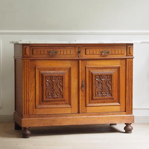 This stylish oak sideboard with a marble top is stylistically classified as Historicist and dates from around 1880–1900....