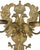 A commanding pair of Continental-style cast-brass candle sconces, combining crowned double-headed eagles, sculptural...