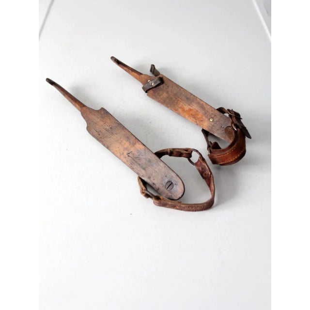 This antique pair of J. Noorham Denham ice skates dates to the late 19th to early 20th century. The Dutch-style wooden...