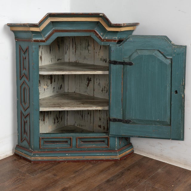 Original painted Swedish hanging corner cabinet dated 1784, crafted in pine with canted sides and front formed with...