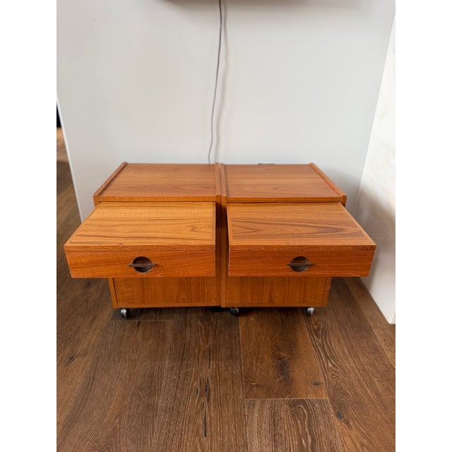 An exceptional pair of authentic Danish Modern rolling bedside cabinets designed by Axelsens Møbelfabrik for W&B Møbler,...