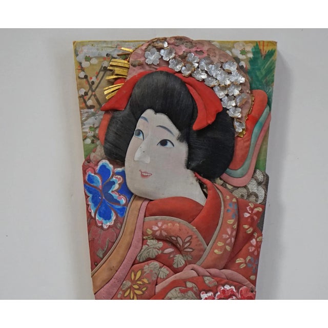 This Hagoita depicts the princess in the Kabuke play Musume Dojo-Ji. This paddle is a wonderful example of the folk art of...