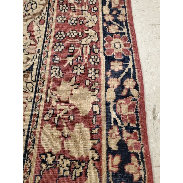 This master crafted Persian Laver Kerman carpet exemplifies the profound understanding of the artistic principles of...