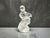 The Lalique figurine is a refined example of artistry and craftsmanship. It depicts a nude female figure with a frosted...
