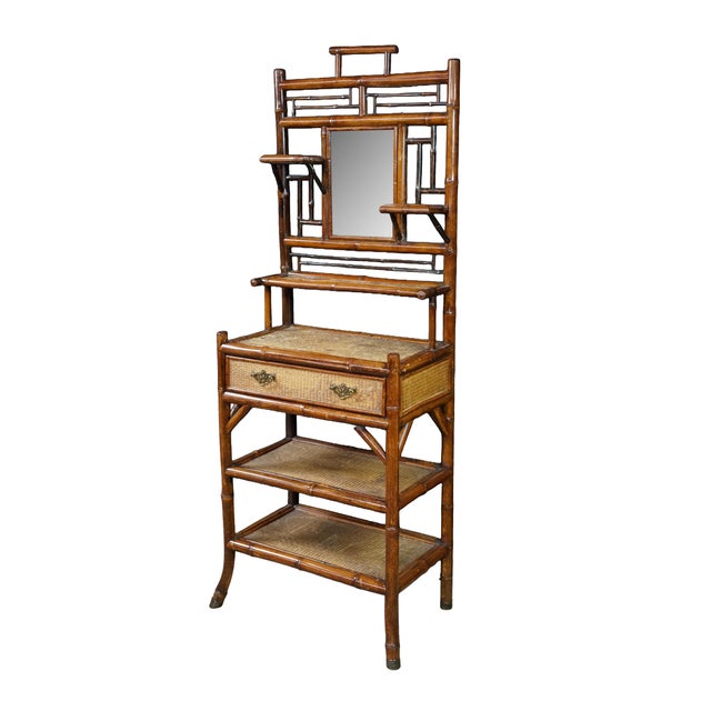 An exquisite antique Victorian bamboo étagère featuring an intricate bamboo frame paired with woven cane paneling...