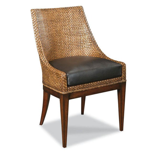 A pleasing, transitionally designed chair features a curved back woven with fine leather. A leather upholstered seat rests...