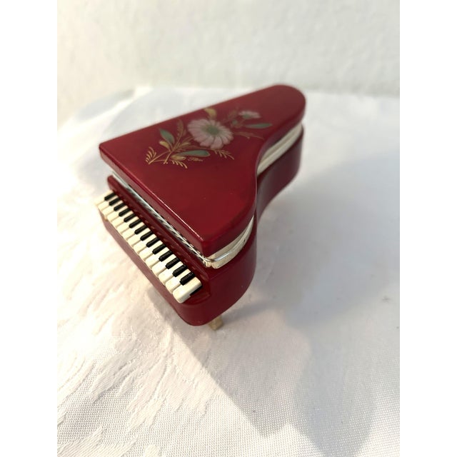 Exquisite mid-century Italian Ruby Red alabaster trinket box in the shape of a piano. Box features gold shaded, molded,...