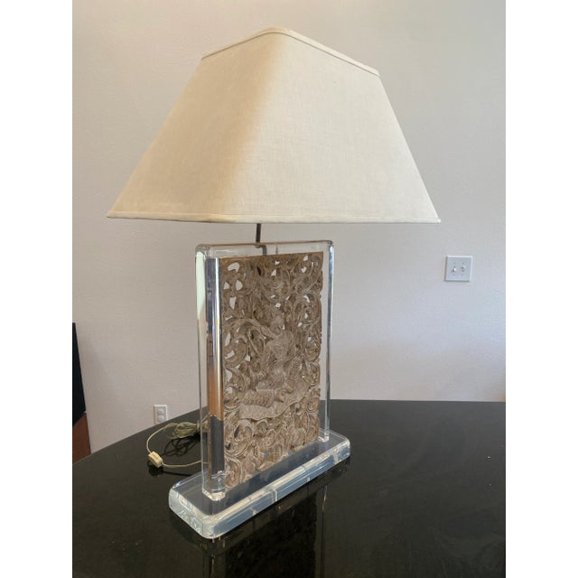 An exceptional custom table lamp featuring an intricately carved Balinese or Southeast Asian architectural panel...