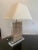 An exceptional custom table lamp featuring an intricately carved Balinese or Southeast Asian architectural panel...