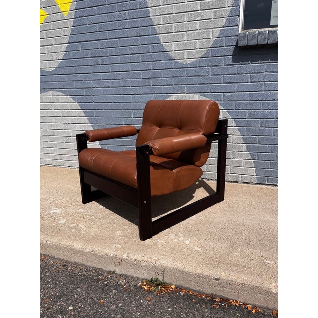 Exceptional Mid-Century Modern lounge chair by Percival Lafer, crafted in Brazil from richly figured Brazilian rosewood...