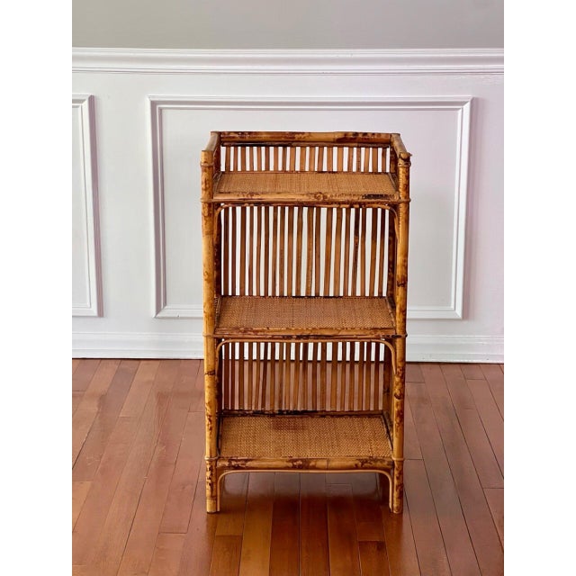 Petite three-tier tortoise burnt bamboo and rattan etagere, 1970s. A wonderful piece offering great versatility that is...