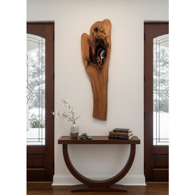 A striking one-of-a-kind wall sculpture handcrafted from a naturally formed solid wood slab. Rather than reshaping the...