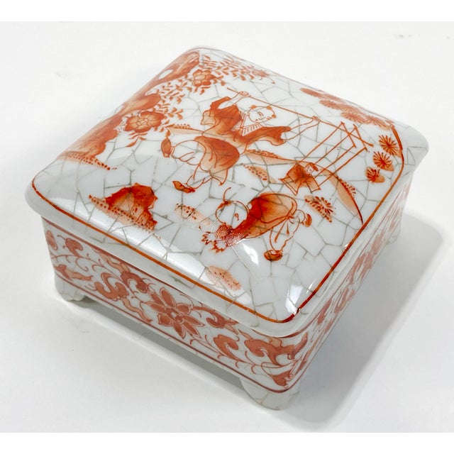 Charming vintage porcelain lidded box featuring whimsical Asian scene to lid and decorated sides to base. Footed with...