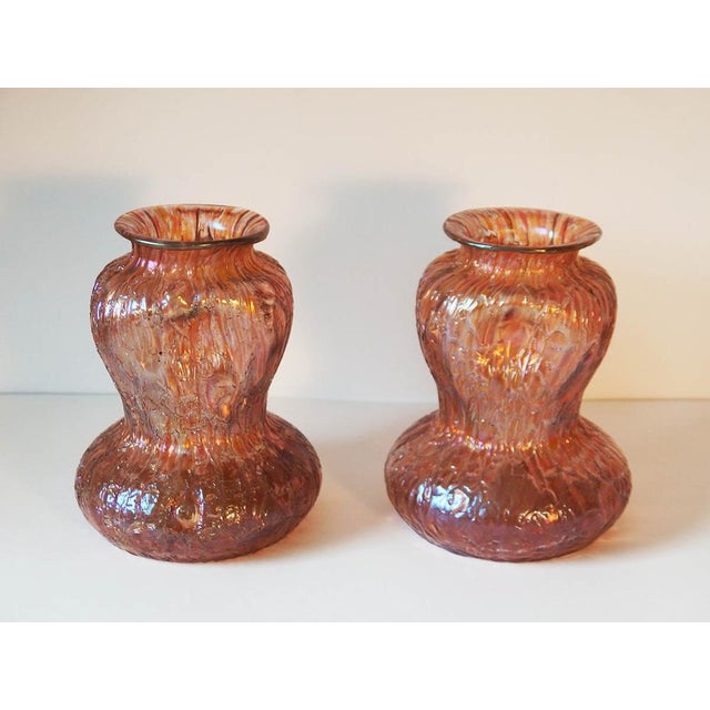 Pair of colored glass vases, slightly iridescent, pink-orange, with a crackled appearance, produced by the Austrian...
