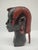 This impressive, hand-carved sculpture of an African head is a prime example of masterful wood carving from the mid-20th...